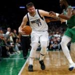 Dallas Mavericks guard Luka Doncic (77) handles the ball against Boston Celtics guard Jaylen Brown (7)