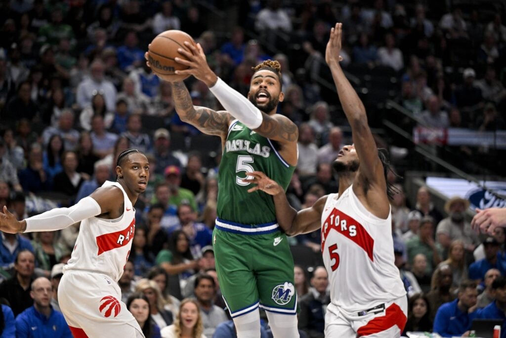 Oct 26, 2025; Dallas, Texas, USA; Dallas Mavericks guard D'Angelo Russell (5) drives to the basket past Toronto Raptors guard Immanuel Quickley (5) during the second half at the American Airlines Center. Mandatory Credit: Jerome Miron-Imagn Images