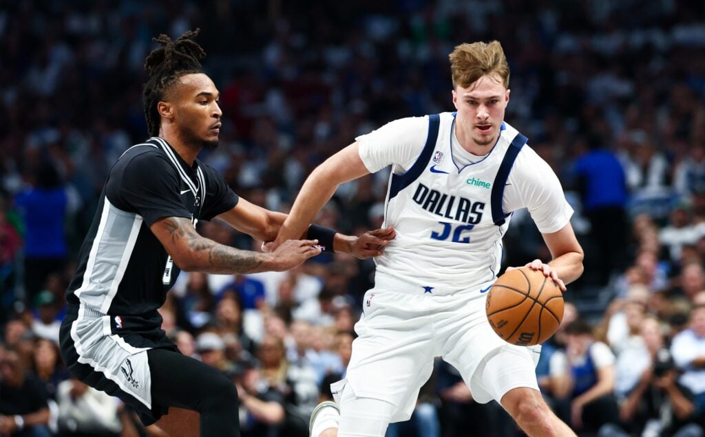 Dallas Mavericks forward Cooper Flagg (32) dribbles as San Antonio Spurs guard Stephon Castle (5) defends during the first quarter at American Airlines Center.